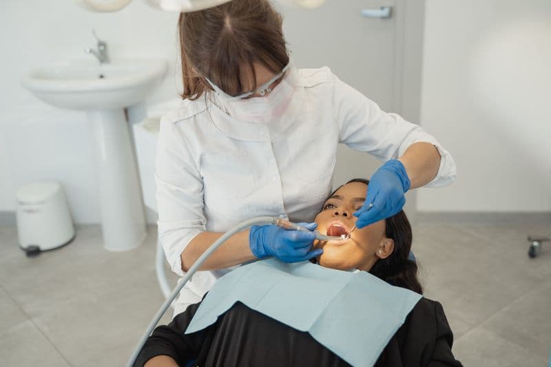 Dentist examining a patient's teeth during a routine checkup
